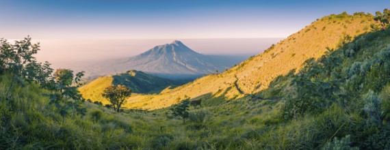 Panoramic photo of mountains surrounding Mount Merbabu near Yogya in central Java province in