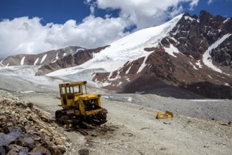 Abandoned broken bulldozer. Kok-Airyk pass, Tien Shan mountains, Kyrgyzstan