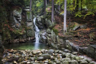 Waterfall in autumn forest of Karkonosze Mountains, Przesieka, Poland