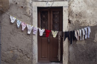 Clothesline in front of front door in Alfama, the old town of Lisbon, Portugal
