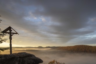 Mystical sunrise at the Wachtfelsen. Fascinating landscape shot between fog and clouds near