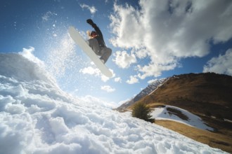 Extreme winter sports. Young professional woman snowboarder rides a halfpipe. Jumps from a halfpipe