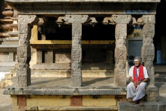 Old man sitting in front of Kandarathithan Gopuram in Virudhagireeswarar Shiva temple in