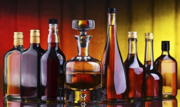 Composition with bottles of assorted alcoholic beverages