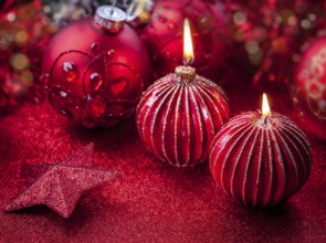 Christmas candles in red tone with glittering background