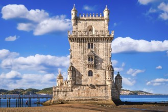 Landmark of Belem tower, Lisbon, Portugal at blue summer day sky with clouds. Medieval