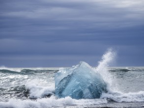Diamond Beach, iceberg in the surf, near Jökulsarlon glacier lagoon, Vatnajökull National Park,