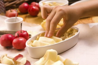 Detail of child hands making apple pie, lodz, poland