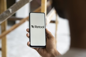 retool logo is displayed on smartphone. Retool is a fast way to build internal tool