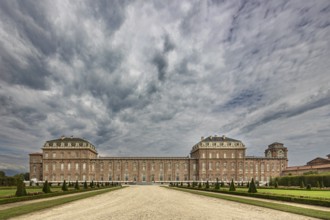 Impressive view of a large baroque palace with clouds in the sky, Palace of Venaria Reale,