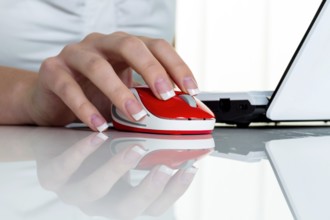 Woman in office with computer mouse. Correct working posture Austria