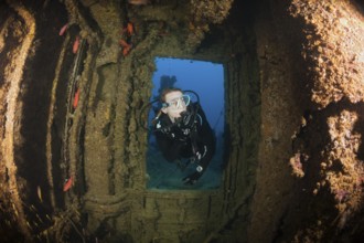 Divers at the stern of the Maldive Victory wreck, Hulhule, North Male Atoll, Maldives