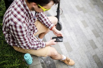 Caucasian man uses modern technologies Internet and cellular communication on smartphone while