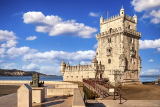 Landmark of Belem tower, Lisbon, Portugal at blue summer day sky with clouds. Medieval