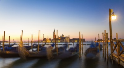 Gondolas at sunrise with San Giorgio di Maggiore church, Venice, Venezia, Italy