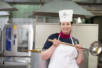 May 31, 2021 Belarus, Gomel, industrial kitchen. Chef in an industrial kitchen smiling and looking