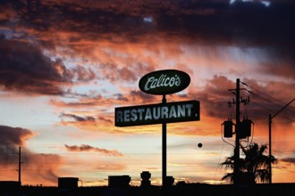 Restaurant sign in front of a dramatic evening sky, Kingman, Arizona, USA