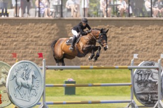 Katie Laurie of Australia and riding Django II, compete in the 1.60m Grand Prix during The