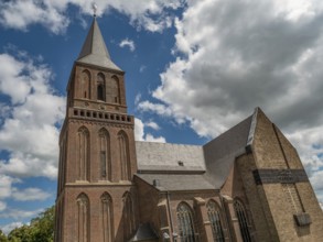 Gothic church under a bright blue sky with white clouds, emmerich, lower rhine, germany