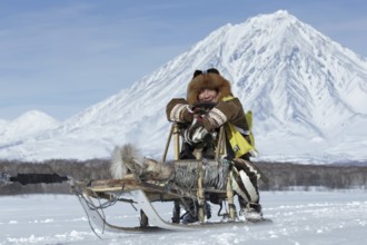 KAMCHATKA, RUSSIA, FEB 25, 2017: Kamchatka musher Mandyatov Roman dressed in national clothes rides