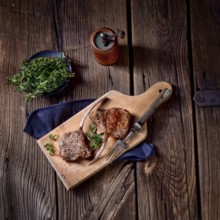 Grilled lamb chops on an old board