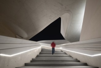 Unrecognized person walking at the stairs leading to a bright open space. Eleftheria square Nicosia