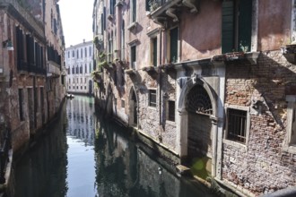 Typical alley named rio awash of sunlight morning. Venice, Veneto. Italy