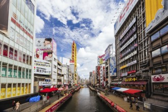 OSAKA, JAPAN - SEPTEMBER 24 2024: The view down Dotonbori River from Ebisubashi Bridge on a clear