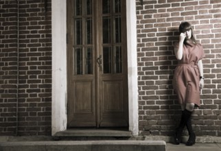 Beauty Woman Standing Against Old Brick Building