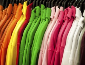 Colorful t-shirts hanging on a rack
