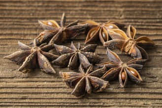 Dried star anise spice on vintage wooden board