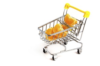 Particles of peeled tangerine in a shopping cart isolated on white background