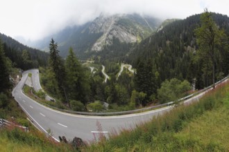 A winding mountain road - Serpentine, lighted autumn sun. Photo taken by lens Fisheye