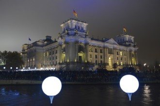 Berlin Reichstag building with light balloons of the former course of the Wall
