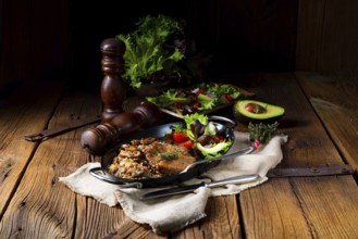 Pork steak with mushrooms and buckwheat groats and mango salad