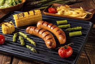 Grilled krakauer with french fries and green salad