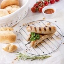 Delicious bratwurst with ketchup and fresh rolls