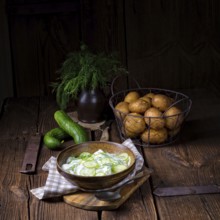 Fresh cucumber salad with yoghurt and young potatoes
