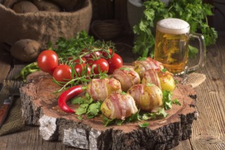 Baked potatoes wrapped in ham