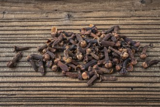 Clove spice on a wooden board, Syzygium aromaticum