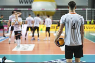Volleyball player serves ball during the match