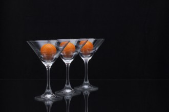 Three glasses of champagne with golf balls