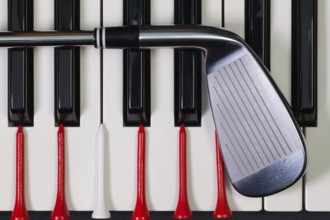 Virtuosic game - Piano keyboard and different golf equipments