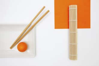 Top View Of White Empty Sushi Plates With Bamboo Chopsticks and Golf Ball. Golf Design