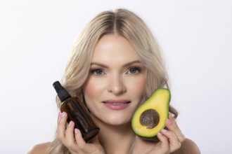 A model elegantly showcasing avocado along with beauty oil specifically designed for natural