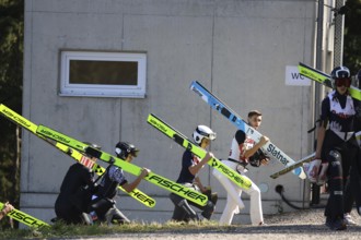 Ski jumpers on their way to the inrun tower at the Alpencup Ski Jumping Hinterzarten 2024,