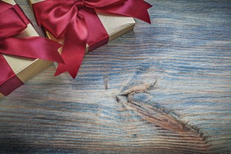 Gift boxes with tied bows on vintage wooden board holidays concept