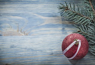 Pine branch Christmas ball on wooden board copy space holidays concept