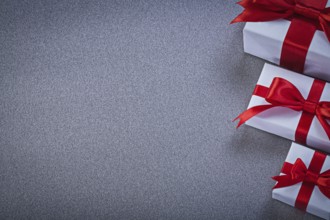 White gift boxes with presents on grey surface holidays concept