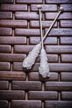 Tasty sugar sticks on wooden matting food and drink concept